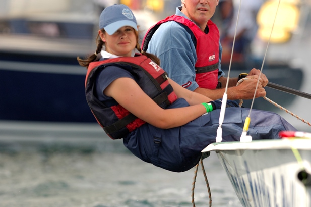 Young girl hiking out on a sailing dinghy in Mylor near Falmouth