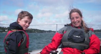 Mother and son sailing on a boat in Mylor Cornwall