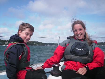 Mother and son sailing on a boat in Mylor Cornwall