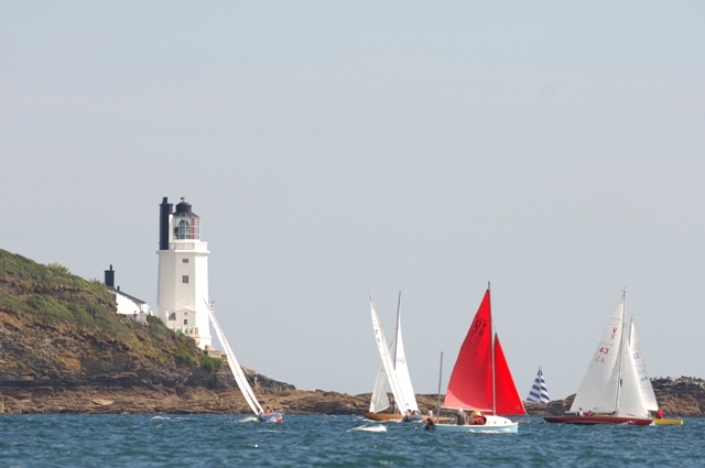 Light house and a few boats sailing in the Carrick Roads near Mylor Sailing School, Falmouth Cornwall