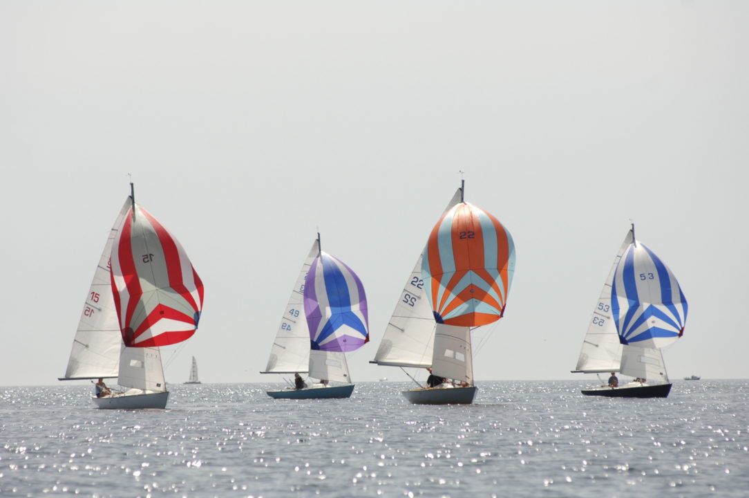 Ajax boats sailing at Falmouth with their colourful spinnaker sails, Mylor Sailing School Cornwall