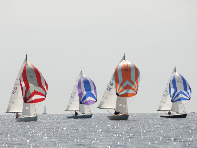 Ajax boats sailing at Falmouth with their colourful spinnaker sails, Mylor Sailing School Cornwall