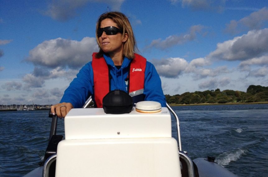 Lady driving a motorboat at Mylor Sailing School Falmouth Cornwall