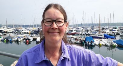 Shorebased trainer lady with glasses and brown hair smiling Suzanna Allin trainer at Mylor Sailing School