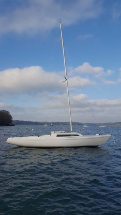 White keelboat on swing mooring at Mylor Sailing School Falmouth Cornwall