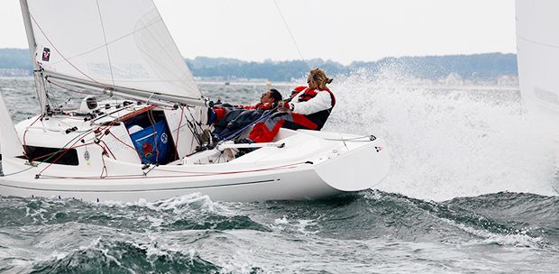 H Boat sailing with 2 people in windy conditions at Mylor Sailing School Falmouth Cornwall