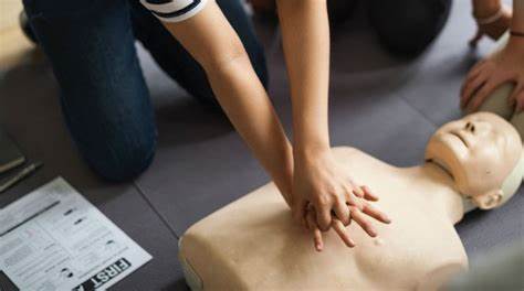 Adult practicing CPR on a Annie doll