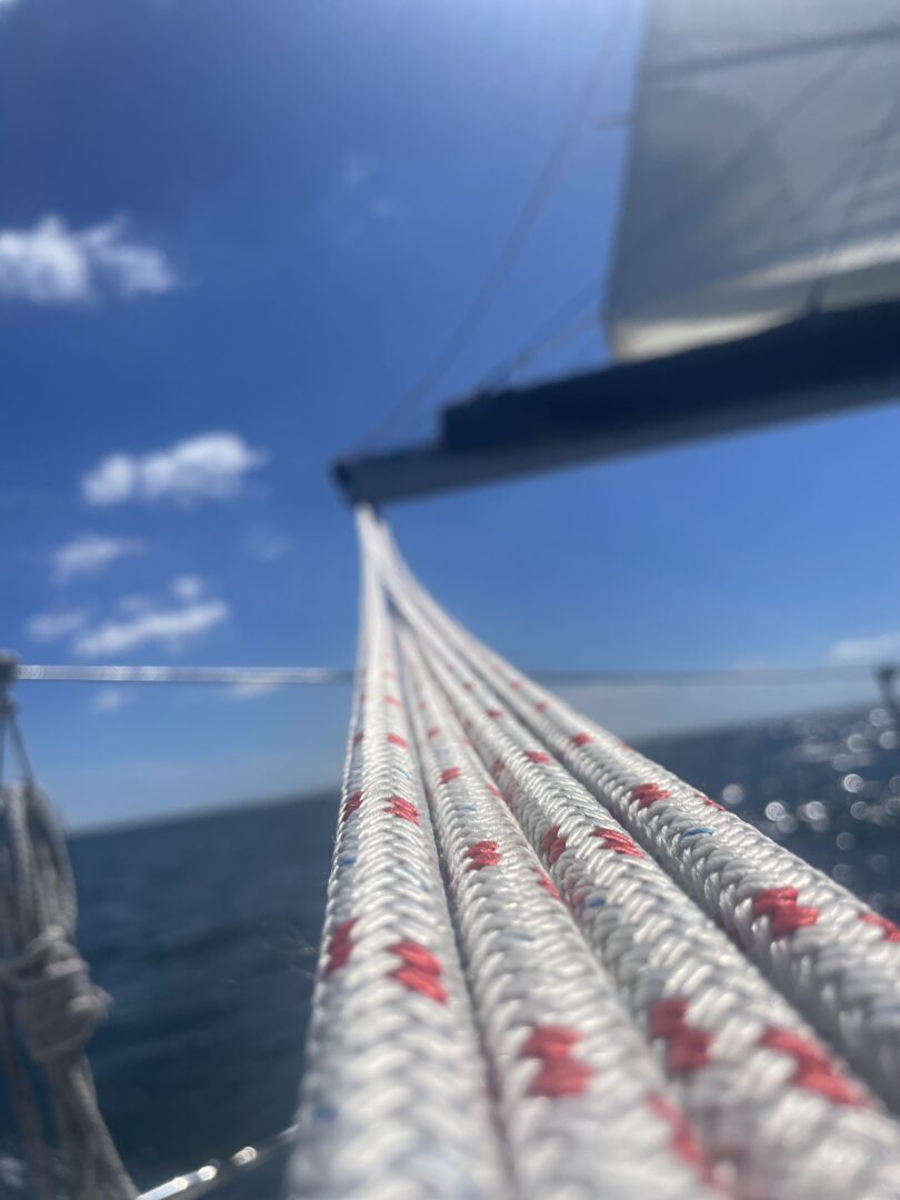 sailing boat with ropes and sea in the background