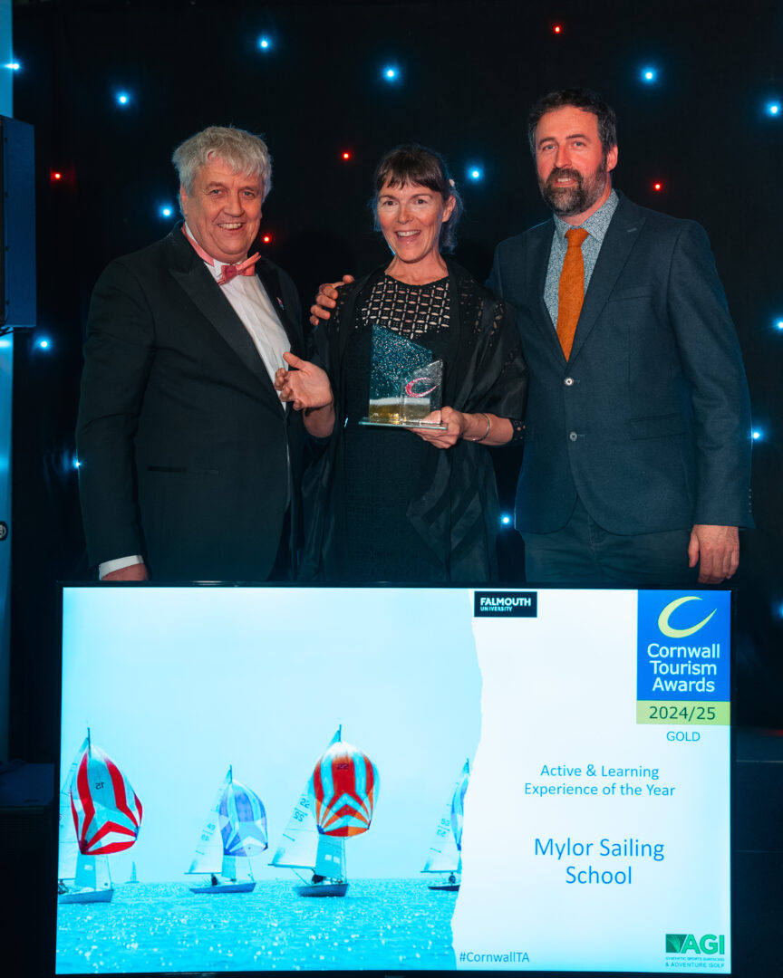 mylor sailing school staff with the awards ceremony tourism board colleagues standing in front of a lit up screen